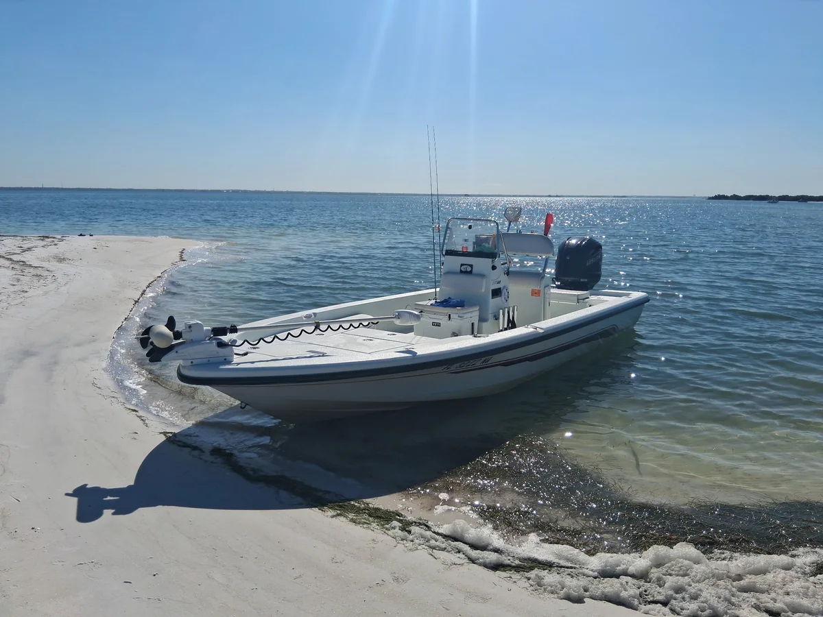 Captain George’s 22-foot Ranger Bay at a sandy shoreline